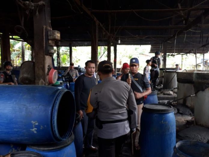 GEREBEK. Petugas tengah menggerebek salah satu lokasi produksi arak terbesar di Kabupaten Bengkayang, Senin (16/4)--Humas Polda Kalbar for RK