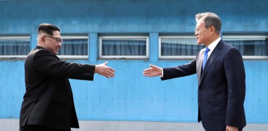 Trump Kecele Lagi DAMAI DALAM PROSES. Pemimpin Korea Utara, Kim Jong-Un (kiri) berjabat tangan dengan Presiden Korea Selatan Moon Jae, di atas garis demarkasi militer di desa perbatasan, Panmunjom, di Zona Demiliterisasi. Korea Summit Press/AP