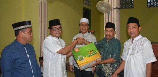 Tajudin: Jaga Persatuan dan Kesatuan Umat Muslim Ketua DPRD Melawi, Abang Tajudin menyerahkan bingkisan kepada Ketua Masjid At Taqwa Desa Manggala, Kecamatan Pinoh Selatan, Unun Supiyatna.