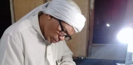 Menulis Rajah Datangkan Berkah MENULIS AYAT ALQURAN. Usman Khalid sedang menyelesaikan rajah ayat suci Alquran di sebuah kertas di rumahnya, Desa Langko, Kecamatan Lingsar, Lobar. Lombok Pos Photo