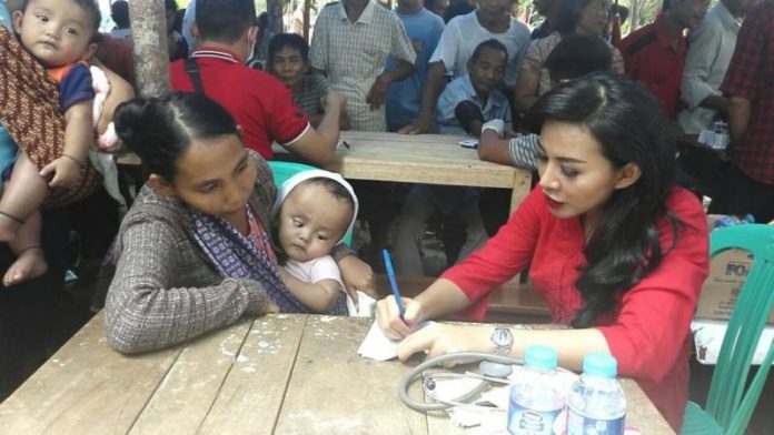 Karolin ketika melayani pasien dalam kunjungan lapangan.