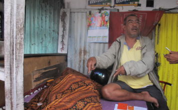 Dua Kali Kios Ismail Dijadikan Tempat Menghembuskan Nafas Terakhir JENAZAH. Seorang warga duduk di samping jenazah Kaspin, lansia yang meninggal di kios milik Ismail, di Jalan Tanjungpura, Pontianak Selatan, Rabu (1/8)--Maulidi Murni.